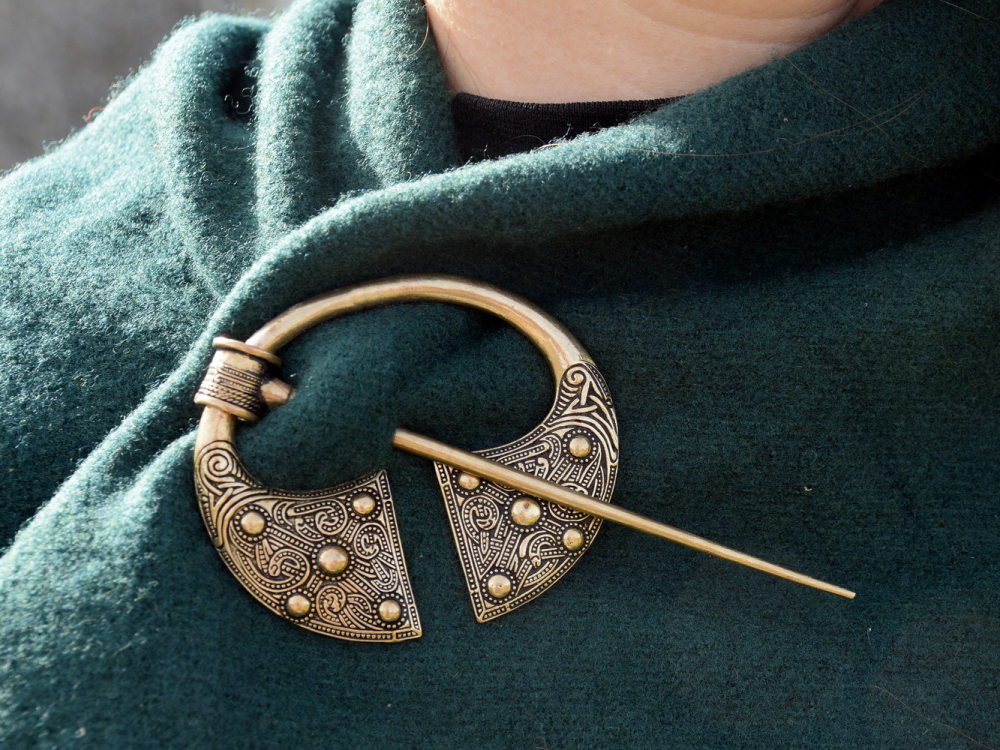 Viking ring brooch in use