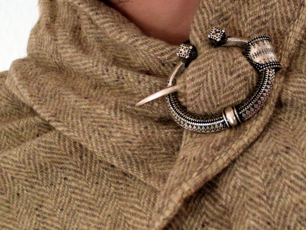 Viking Age ring brooch in use